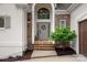 Elegant entryway with stone accents, a decorative wreath, and stylish outdoor lighting at 20312 Deep Cove Ct, Cornelius, NC 28031