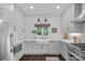Beautiful white kitchen featuring modern appliances, bright countertops, and ample cabinet space at 20312 Deep Cove Ct, Cornelius, NC 28031