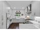 Bright kitchen features white cabinets, modern appliances, and a stylish farmhouse sink at 20312 Deep Cove Ct, Cornelius, NC 28031