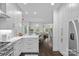 Modern kitchen features white cabinets, quartz countertops, stainless steel appliances, and an open layout at 20312 Deep Cove Ct, Cornelius, NC 28031