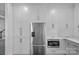 Modern kitchen with stainless steel refrigerator, built-in microwave, and white cabinetry at 20312 Deep Cove Ct, Cornelius, NC 28031