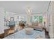Open concept living area seamlessly connects to the kitchen and features hardwood floors and a modern chandelier at 20312 Deep Cove Ct, Cornelius, NC 28031