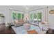 Bright living room boasts natural light, a decorative chandelier, and views of the outdoor deck at 20312 Deep Cove Ct, Cornelius, NC 28031