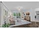 Elegant living room with a decorative chandelier, large windows, and access to the outdoor deck at 20312 Deep Cove Ct, Cornelius, NC 28031
