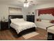 Cozy bedroom with a plush bed, dark wood furniture, and a sunny window seat at 205 Wellington Hills Cir # 205, Salisbury, NC 28147