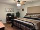 Bedroom featuring desk with dual computer screens, ceiling fan and a bed with patterned bedding at 205 Wellington Hills Cir # 205, Salisbury, NC 28147