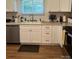 Well-lit kitchen boasts granite counters, modern white cabinets, and a stainless steel dishwasher at 205 Wellington Hills Cir # 205, Salisbury, NC 28147