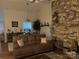 Spacious living room boasts a decorative brick wall, plush seating, and stylish decor, adjacent to the dining area at 205 Wellington Hills Cir # 205, Salisbury, NC 28147
