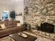 Inviting living room featuring a brick accent wall, cozy fireplace, and comfortable seating arrangement at 205 Wellington Hills Cir # 205, Salisbury, NC 28147