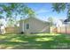 Spacious backyard featuring a wooden fence, green lawn and mature tree branches overhead at 210 E 5Th Ave, Gastonia, NC 28054