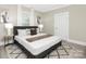 Bedroom with large bed, grey rug, side tables, and white walls at 210 E 5Th Ave, Gastonia, NC 28054