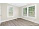 Bedroom with wood floors, light-colored walls, and multiple large windows at 210 E 5Th Ave, Gastonia, NC 28054