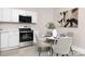 Bright kitchen featuring stainless steel appliances and a cozy breakfast table with seating at 210 E 5Th Ave, Gastonia, NC 28054