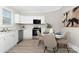 Charming kitchen with white cabinets, modern appliances, and a delightful breakfast nook at 210 E 5Th Ave, Gastonia, NC 28054