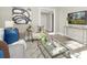 Comfortable living room featuring modern decor, a gray sofa, and a stylish glass table at 210 E 5Th Ave, Gastonia, NC 28054