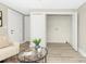 Cozy living room featuring light-colored walls, wood floors, and a closet with laundry hookups at 210 E 5Th Ave, Gastonia, NC 28054