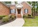 Charming brick home with a covered front porch and well-manicured landscaping at 212 Victoria Cir, York, SC 29745