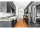 Stylish kitchen featuring modern appliances, granite counters, and sleek black cabinetry at 212 Victoria Cir, York, SC 29745