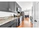Well-lit kitchen features stainless appliances, granite counters, and dark cabinetry at 212 Victoria Cir, York, SC 29745