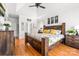 Spacious primary bedroom featuring tray ceilings, a wooden bed frame, and wood laminate flooring at 212 Victoria Cir, York, SC 29745