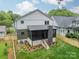 An aerial view of a backyard featuring a screened porch and manicured lawn at 2412 Kingsbury Dr, Charlotte, NC 28205