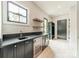 This bar area showcases a sleek countertop, a beverage cooler, and stylish wood floating shelves, providing an inviting space at 2412 Kingsbury Dr, Charlotte, NC 28205