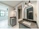 Dual sink bathroom vanity featuring black faucet fixtures and arched mirrors at 2412 Kingsbury Dr, Charlotte, NC 28205