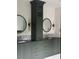 Bathroom vanity with double sinks, decorative mirrors, and dark green cabinetry at 2412 Kingsbury Dr, Charlotte, NC 28205