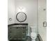 Bathroom featuring a modern vanity, circular mirror, and glass-enclosed shower at 2412 Kingsbury Dr, Charlotte, NC 28205