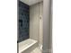 This bathroom showcases stylish blue tiles around the tub, complemented by sleek gray tiles on the adjacent wall at 2412 Kingsbury Dr, Charlotte, NC 28205