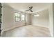 Light-filled bedroom with hardwood flooring, fan, and two large windows for ample natural light at 2412 Kingsbury Dr, Charlotte, NC 28205
