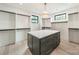 A stylish closet features built-in shelving, central island and a glamorous chandelier at 2412 Kingsbury Dr, Charlotte, NC 28205