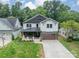 Beautiful new construction home boasts lush green lawn and two car garage at 2412 Kingsbury Dr, Charlotte, NC 28205