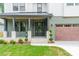 Charming home exterior with green siding, craftsman details, and a two-car garage at 2412 Kingsbury Dr, Charlotte, NC 28205