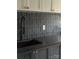 The kitchen boasts gray backsplash tiles with a black faucet, sleek countertops, and modern cabinetry at 2412 Kingsbury Dr, Charlotte, NC 28205