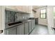 Laundry room featuring geometric tile floors and gray cabinets and countertop at 2412 Kingsbury Dr, Charlotte, NC 28205