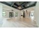 Expansive living area with black ceiling beams, recessed lighting, and hardwood floors at 2412 Kingsbury Dr, Charlotte, NC 28205