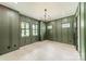 Spacious living room with decorative paneling, light hardwood floors, and three windows at 2412 Kingsbury Dr, Charlotte, NC 28205