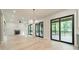 Elegant living area with fireplace, chandelier, and sliding doors to screened-in porch at 2412 Kingsbury Dr, Charlotte, NC 28205