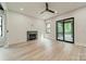 Contemporary living room features a fireplace, ceiling fan, and sliding glass doors at 2412 Kingsbury Dr, Charlotte, NC 28205