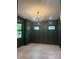 Living room features dark green walls, black trim, hardwood floors, and a modern chandelier at 2412 Kingsbury Dr, Charlotte, NC 28205