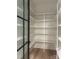 Walk-in pantry features white shelving, hardwood floors, and a decorative glass door at 2412 Kingsbury Dr, Charlotte, NC 28205
