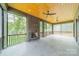 A luxurious screened porch with a stone fireplace, and a wood ceiling at 2412 Kingsbury Dr, Charlotte, NC 28205