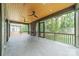 A spacious screened porch with a stone fireplace, ceiling fans, and wood ceiling at 2412 Kingsbury Dr, Charlotte, NC 28205