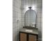 Chic powder room with marble countertop, gold fixtures, and black and white patterned wallpaper at 2412 Kingsbury Dr, Charlotte, NC 28205