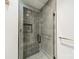 Modern shower room featuring gray vertical tiles, glass door, and bronze hardware at 2412 Kingsbury Dr, Charlotte, NC 28205