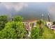 Aerial view showcasing the waterfront home, dock, and lush greenery along the shoreline at 270 Yachtsman Dr, Salisbury, NC 28146