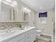 Bathroom featuring double sinks, decorative mirrors, and tiled backsplash at 270 Yachtsman Dr, Salisbury, NC 28146