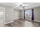 Bedroom featuring hardwood floors, ceiling fan, lake view window, and access to other rooms at 270 Yachtsman Dr, Salisbury, NC 28146