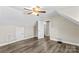 Spacious bedroom with hardwood floors, vaulted ceilings, fan and light fixture, and access to additional rooms and closets at 270 Yachtsman Dr, Salisbury, NC 28146